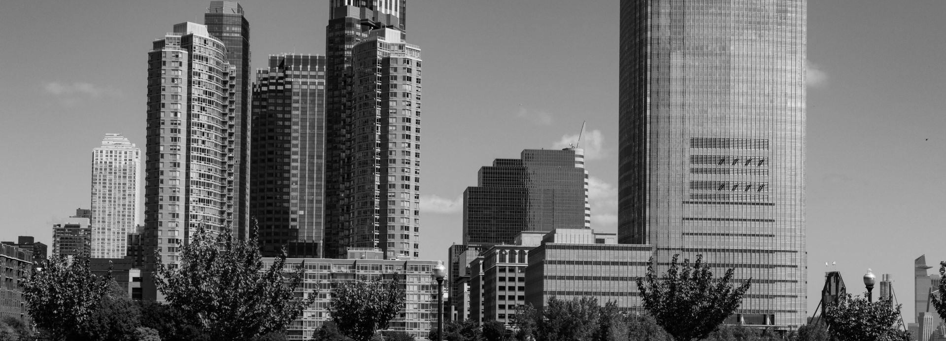 Dramatic black and white photo of Jersey City's distinctive skyline on a clear day.
