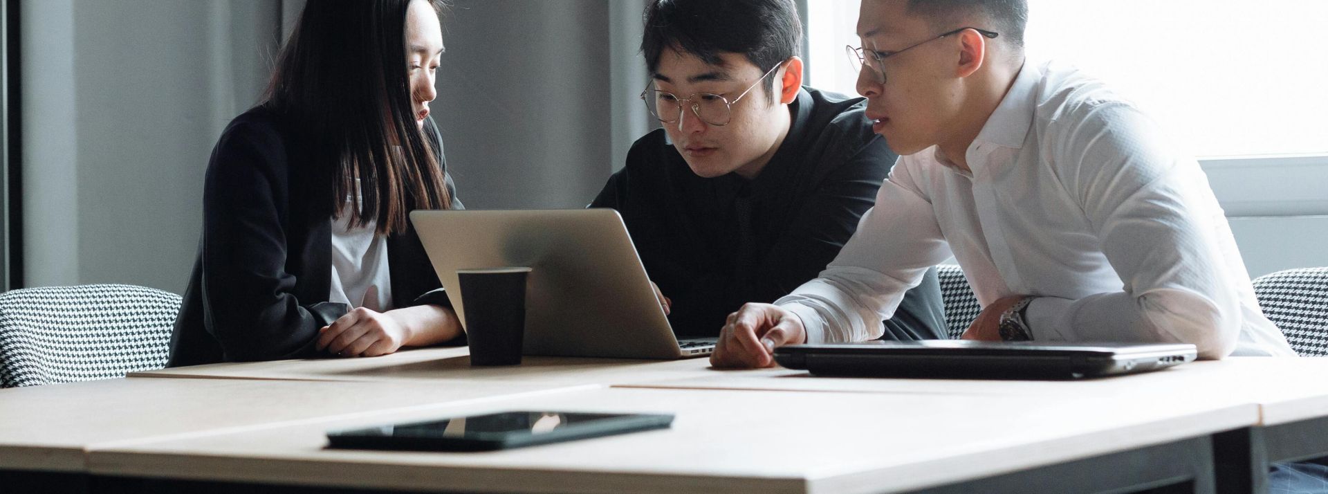 Diverse group of professionals collaborating on a project in a modern office environment.