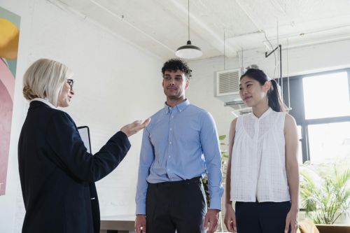 Professional discussion among diverse colleagues in a modern office setting.