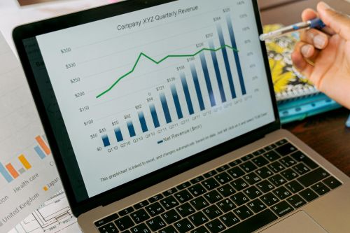 A close-up view of a laptop displaying business analytics and revenue charts.