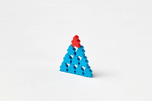 A stack of blue and red wooden blocks arranged in a triangle on a white background.